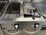 two deep fryers sitting on the counter in the kitchen