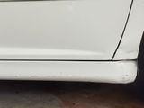 a close up of a white car with the door handle missing