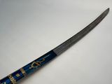 an image of a blue and gold samurai sword on a white surface