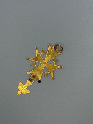 a gold snowflake on the surface of a gray surface