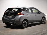the back end of a silver nissan versa parked in a garage