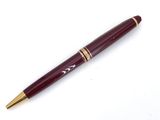 a close up of a pen sitting on top of a white surface