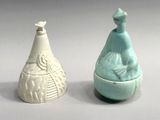 two vases sitting next to each other on a table