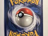 a close up of a pokemon card on a white surface