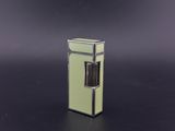 a small green refrigerator sitting on a black surface