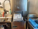 a kitchen with a sink, dishwasher, and other items in it