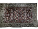 a red and blue rug on a white background