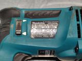 a close up of a corded sander on a table