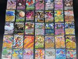 a large collection of pokemon cards sitting on top of a table
