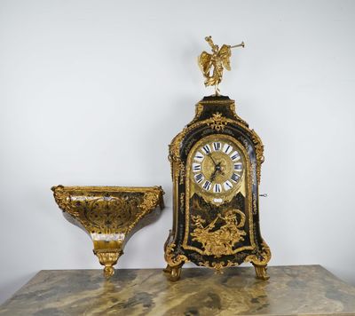 a clock and a bowl sitting on a table