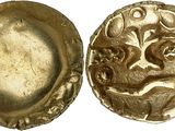 a close up of a gold coin with a bird on it
