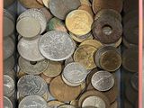 a pink box filled with lots of different types of coins