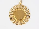 an image of a gold sunburst pendant on a white background