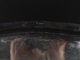 a close up of a person ' s face in a silver bowl