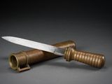 a knife that is laying on top of a tube