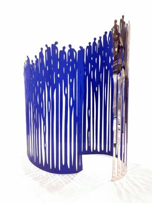 a blue sculpture of a group of people standing in front of a fence