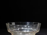 a clear glass bowl sitting on top of a black table