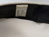 a close up of a black and white hat with a label on it