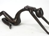 statue of a woman laying on her back on a white surface