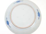a blue and white plate on a white table