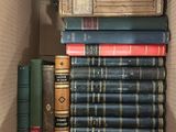 many books in a box that are stacked together