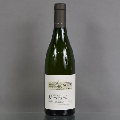 a bottle of wine sitting on a glass table