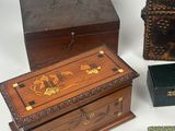 three small wooden boxes with decorative designs on them on a white surface