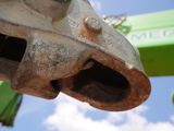a close up of a metal object with a crane in the background