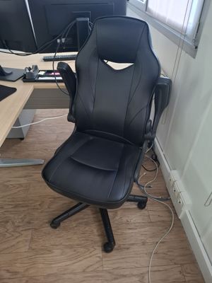 a black office chair sitting in front of a computer monitor