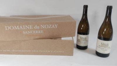 two bottles of wine are sitting next to a box of wine