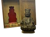 a statue of a buddha sitting in a wooden box