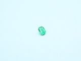 an emerald stone sitting on top of a snow covered ground