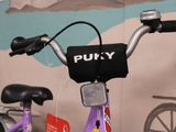 a purple bike that is parked in front of a wall
