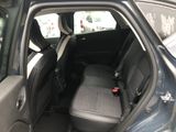 the back seat of a car with the door open in a parking lot
