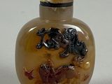 a picture of a glass snuff bottle with a horse design on it