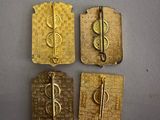four pieces of gold metal with a tre symbol on them