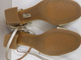 pair of women ' s tan sandals on a white surface