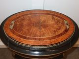a round table with a wooden top and a black base