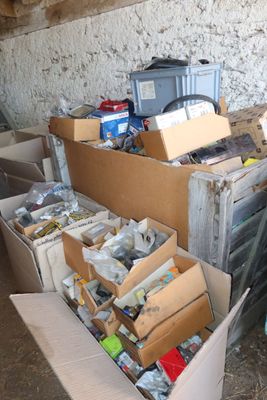 many boxes of assorted items sitting in a room