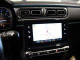 the dashboard of a car with a gps device in the center of it