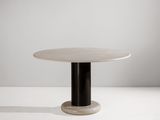 une table blanche avec un piètement noir et un plateau rond