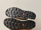 the soles of a pair of hiking shoes on top of a cardboard box