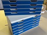 three stacks of blue and white file folders on a table