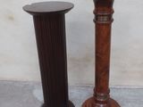 two wooden pedestals sitting next to each other on the floor