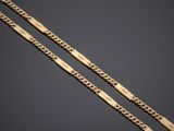 a pair of gold chain bracelets