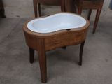a wooden table with a sink on it in the middle of a room
