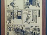 Une vieille bande dessinée est accrochée au mur d'une pièce.