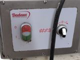 a close up of a machine with a red button and a green button