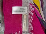 a pink scarf with a tag on it on a hanger