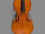an old violin with a bow hanging on a wall